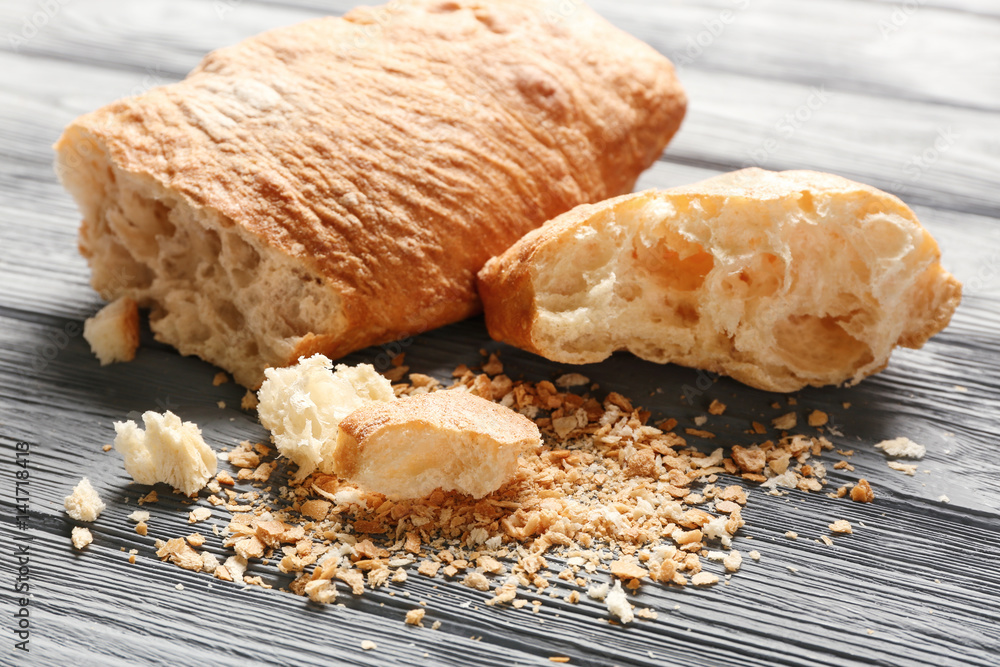 Bread and crumbs on wooden table