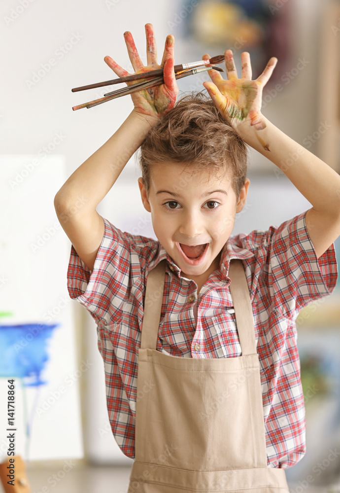 Cute little artist in studio