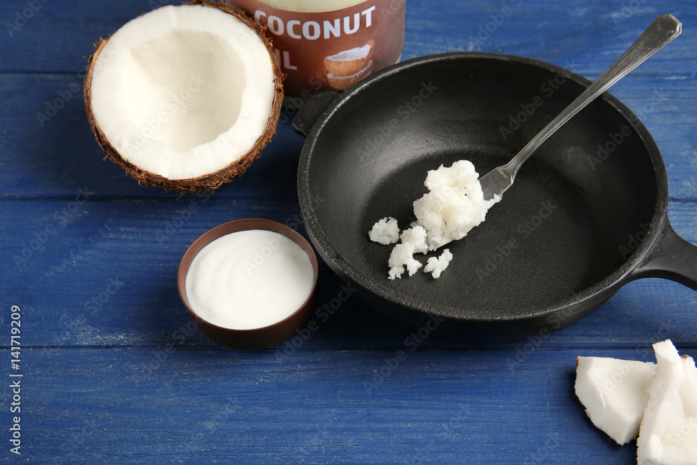 Putting fresh coconut oil on frying pan