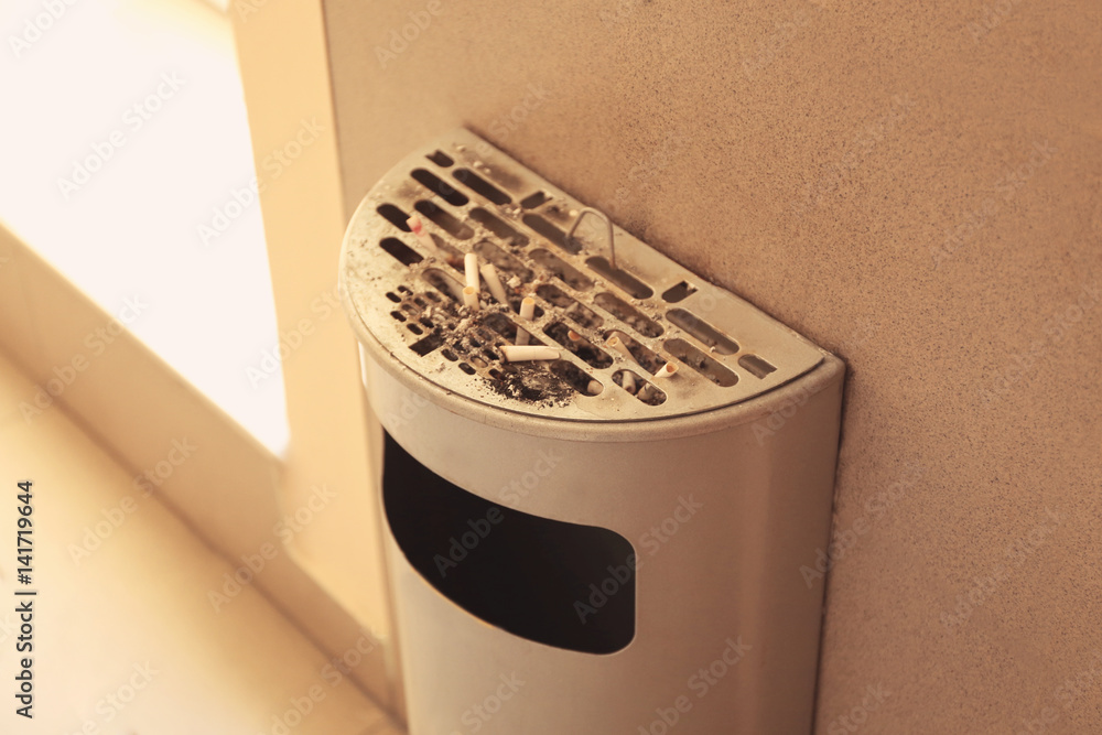 Trash bin with cigarettes butts, indoor