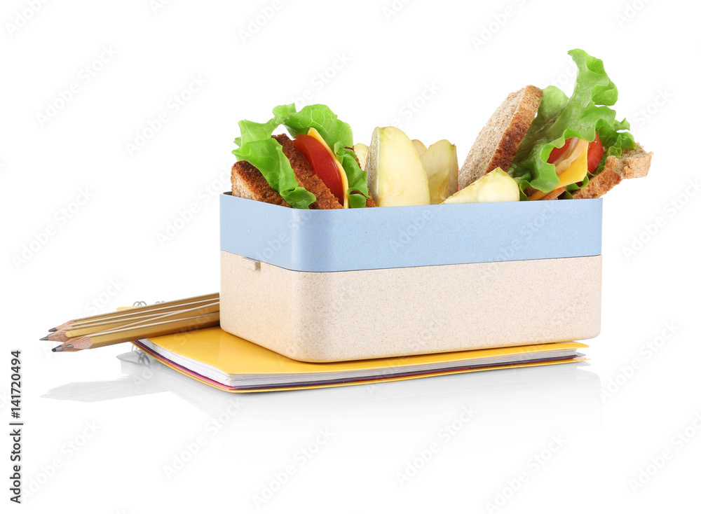 Lunch box with food and stationery on white background