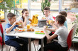 © Africa Studio - Children sitting at cafeteria table while eating lunch