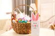 © Africa Studio - Beautiful Easter basket and cute gift bag on white table
