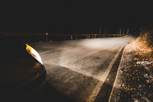 The Headlights Of A Car On Mountain Road In The Night - Concept Driving Safety