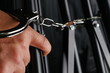© eurostar1977 - The chrome metal handcuffed bondage on man hand represent the crime and punishment equipment concept related idea.