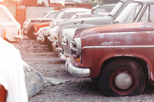 Rows Of Cars In A Salvage Yard Facing Each Other