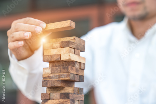 Cuadros en Lienzo Closeup of businessman making a pyramid with empty wooden cubes