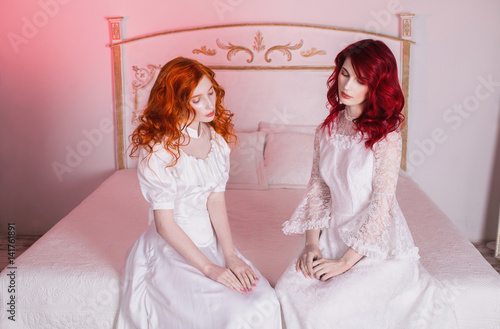 Two Beautiful Girls With Red Hair In A Beautiful White Wedding