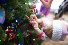Girl Decorating A Christmas Tree