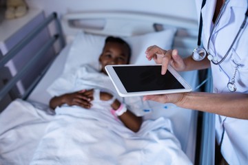 Poster - Female doctor using digital tablet during visit in ward