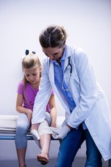 Sticker - Doctor putting bandage on injured leg of patient