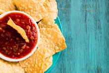 Tortilla Chips And Bowl Of Salsa On Blue Background