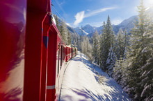 Iconic Swiss Red Bernina Express Train In Winter Landscape And Pristine Snow. Swizerland, Europe.