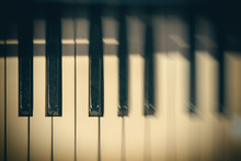 Piano Keyboard Background With Selective Focus And Blur. Blur Keyboard And Musical Notes
