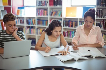 Attentive students studying in library