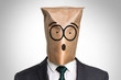 Businessman with a bag on the head - with surprised face