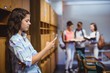 © WavebreakMediaMicro - Schoolgirl using mobile phone in locker room