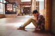 © WavebreakMediaMicro - Sad schoolboy sitting alone in corridor