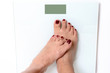 © michaelheim - Woman feet on weight scale