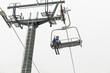 Skier wearing skiing outfit going to the mountain's pike by ski lift