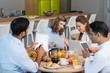 © WavebreakMediaMicro - Business colleagues discussing over digital tablet