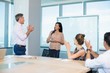 © WavebreakMediaMicro - colleagues clapping for businesswoman in conference room