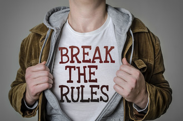 Man showing Break the rules tittle on t-shirt. Positive attitude and success concept.