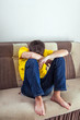 © Sabphoto - Sad Teenager on Sofa