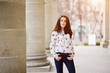 © AS Photo Family - Young stylish brunette girl on shirt and pants posed near stone columns. Street fashion model concept.