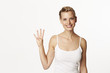 © sanneberg - Stunning woman holding up four fingers, portrait