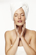 © sanneberg - Serene woman wearing towel, eyes closed