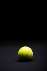 Tennis ball on black