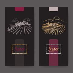 Set of two wine labels with vineyard landscapes.