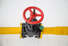 Yellow Gas Pipe And A Red Valve Open