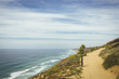 © Cavan Images - High angle view of coastline by cliff against sky