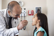 © Cavan Images - Dentist examining girl's teeth in clinic