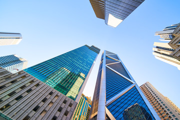 Wall Mural - Low angle shot of modern glass city buildings with clear sky background. Kuala Lumpur , Malaysia .