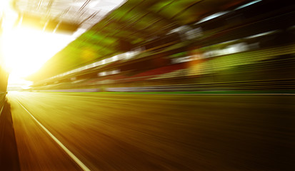 Wall Mural - Foward motion speed lens blur racing circuit background with seated stand , sunset scene  .