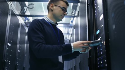 Wall Mural - IT Engineer Taking Hard Drives off the Crash Cart and Putting Them into Rack Server. She's Working in Data Center. Shot on RED EPIC-W 8K Helium Cinema Camera.