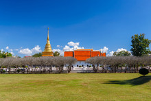 Bright Sky With Grass Field In Nan Museum In Front Of Golden Pagoda In Wat Phra That Chang Kham, Nan Province,Thailand