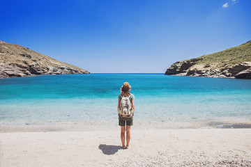 Wall Mural - Female traveler looking at the sea, travel and active lifestyle concept