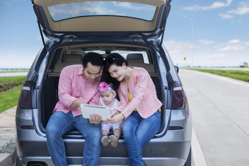 Family looking at map on tablet