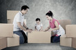 © Creativa Images - Parents and child with cardboard