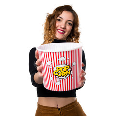 Wall Mural - Beautiful young girl eating popcorns