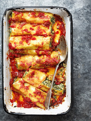 Wall Mural - close up of rustic italian spinach ricotta cannelloni pasta