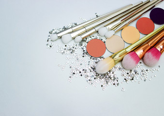 Brushes for make-up and precious stones.