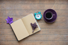 Photo Of Opened Notebook, Bunch Of Lavender, Purple Flower, Alarm Clock And Cup Of Coffee On The Wonderful Wooden Brown Background