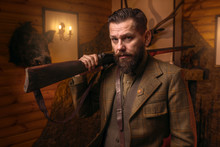Hunter Man In Vintage Clothing With Antique Rifle