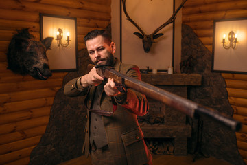 Poster - Hunter man aims of the antique hunting rifle