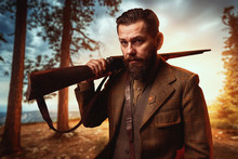 Hunter In Vintage Hunting Clothing With Old Gun